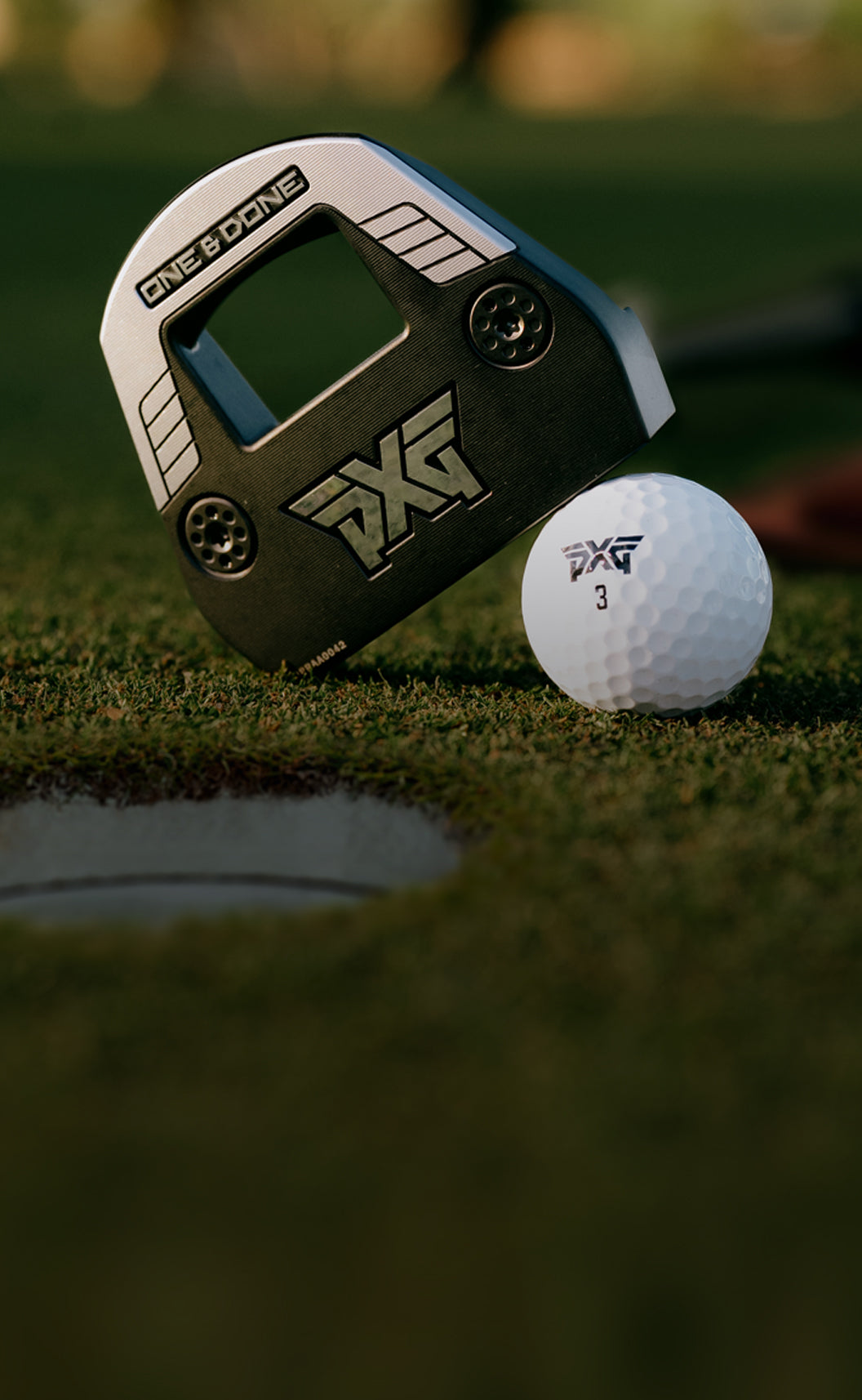 PXG golf ball and launch monitor on a green surface