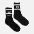 PXG women's black stripe crew socks with white stripes and a white PXG logo on a white background