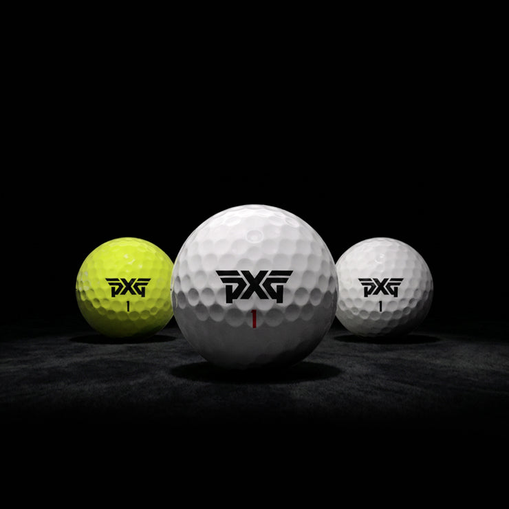 Three golf balls with PXG logo on a dark background