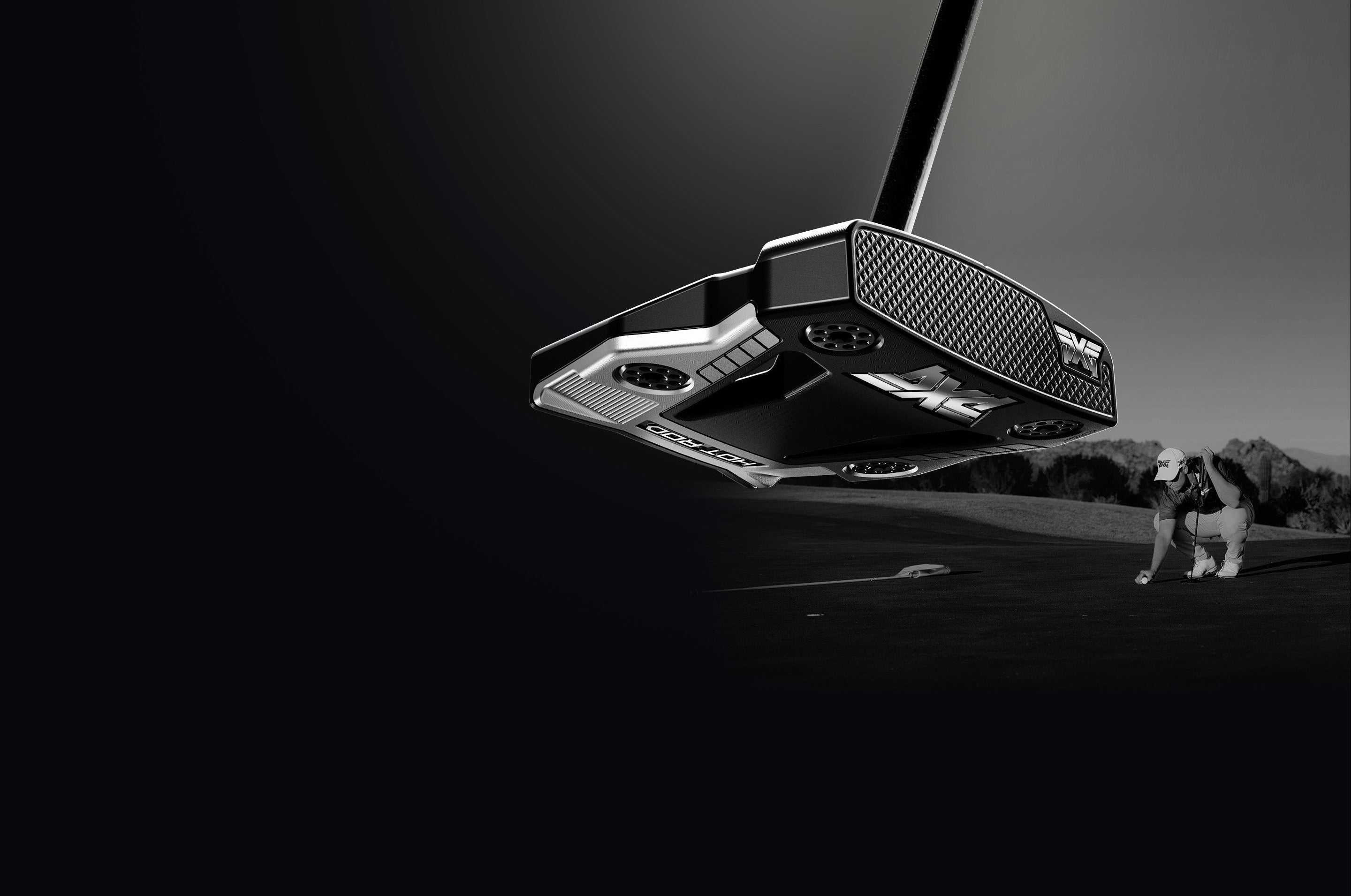 Golf putter with a golf ball on a black background