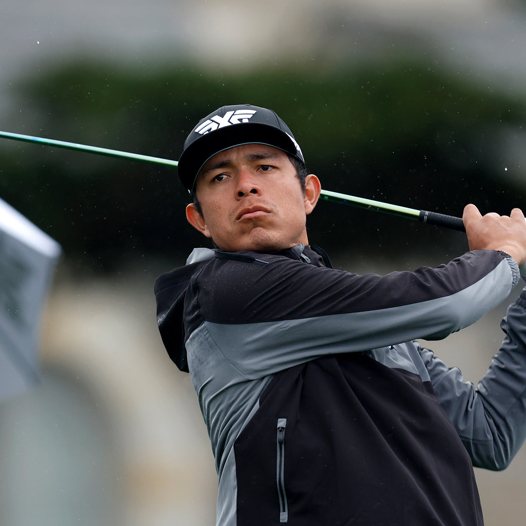 Pro Augusto Nunez wearing a PXG Hat and swinging a golf club on a golf course.