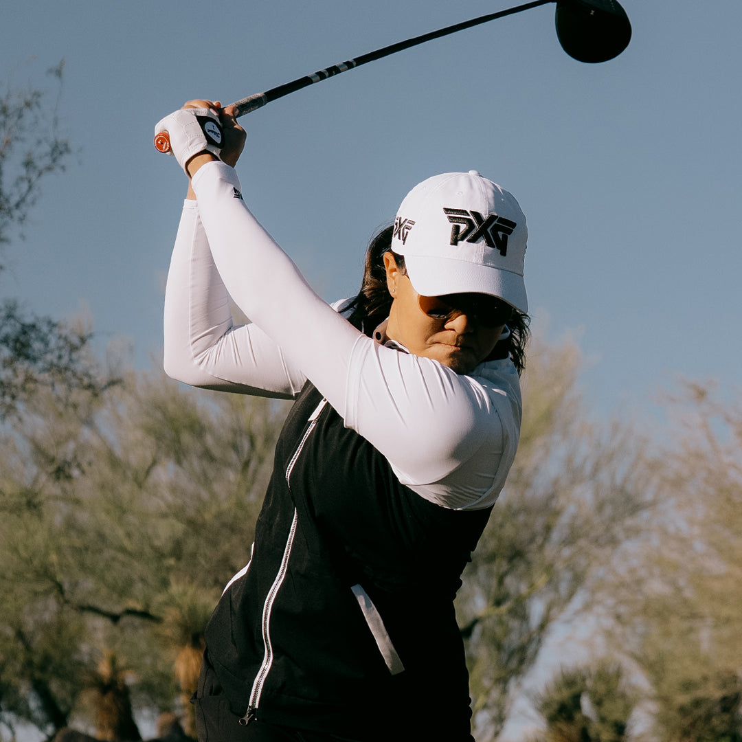 LPGA Tour Pro Auston Kim wearing a PXG Golf Hat on a golf course.