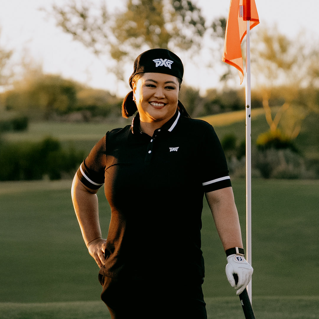 LPGA Tour Pro Christina Kim wearing a PXG Golf Hat and apparel on a golf course.