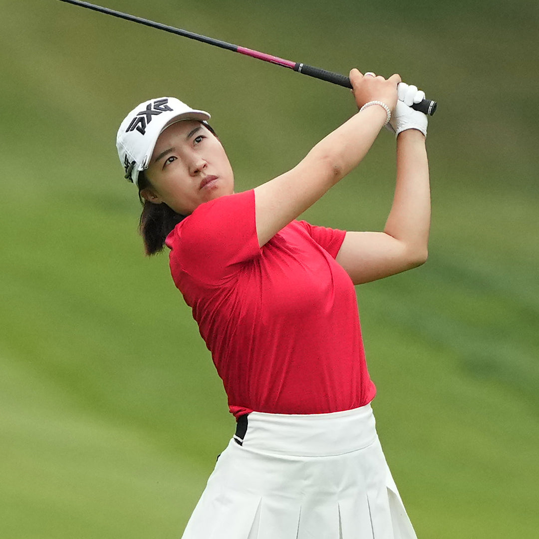 LPGA Tour Pro Minji Kang wearing a PXG Golf Hat on a golf course.