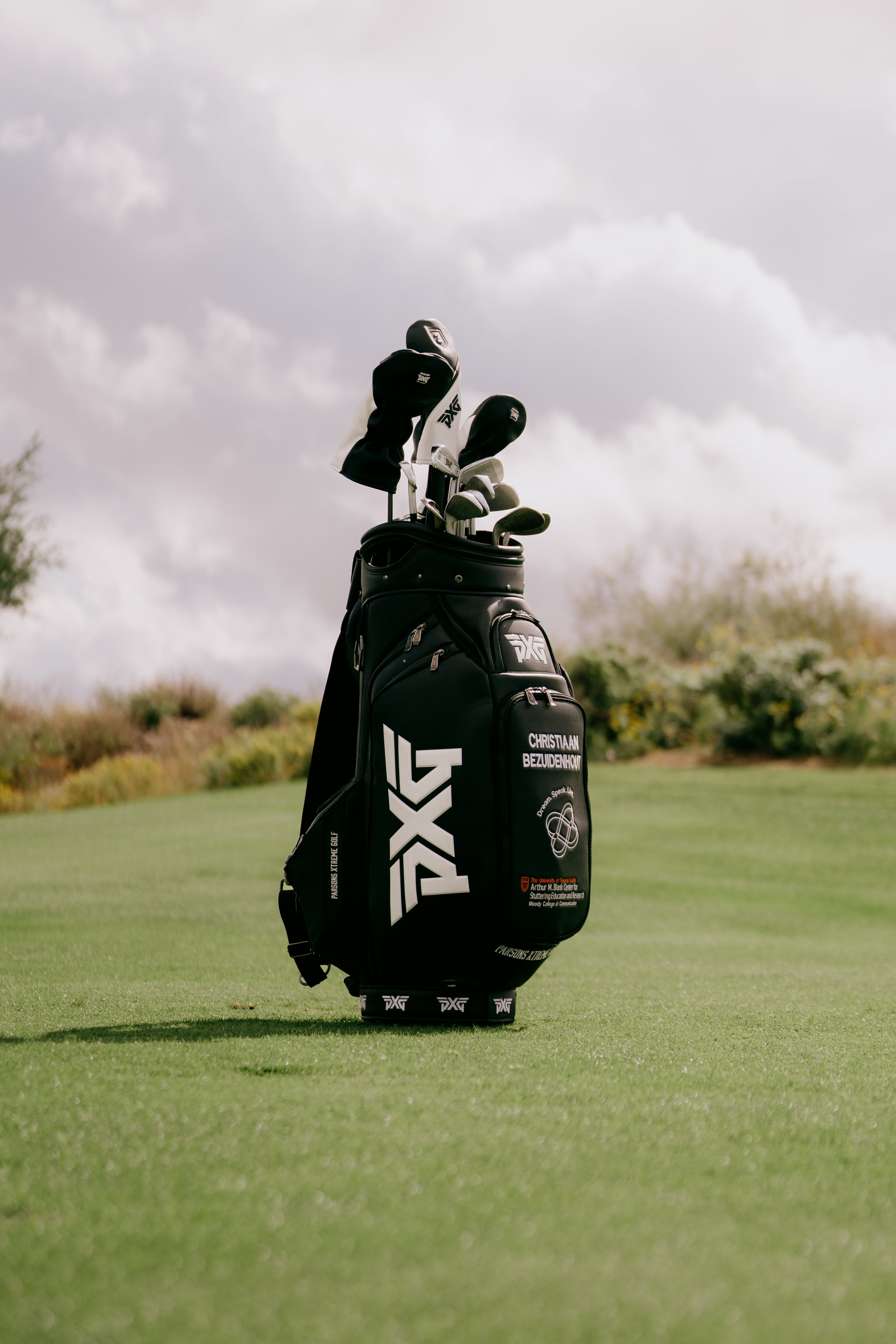 Golf bag with clubs on a golf course