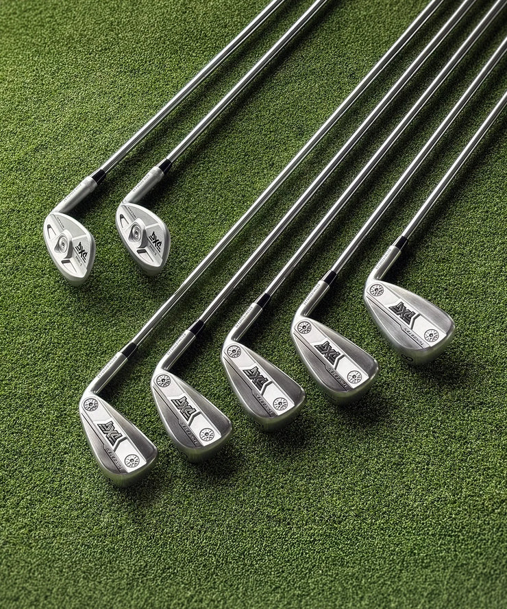 Set of golf clubs on a green surface