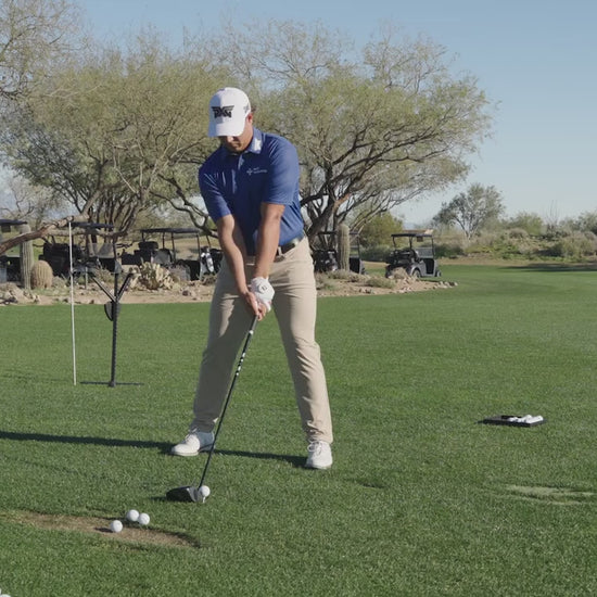 Aldrich Potieter swinging a golf club on a golf course.